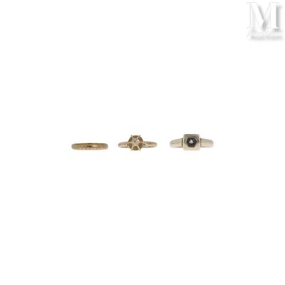 a pair of gold rings with black diamonds on them