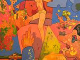 a painting on the wall of a building with a woman on it