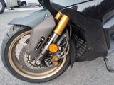 a close up of a motorcycle parked in a parking lot