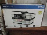 a box with a printer on it sitting on a shelf