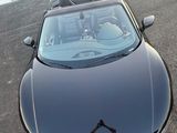 a man taking a picture of a car in the parking lot