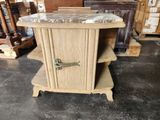 a small table with a marble top in a warehouse