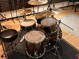 a drum set up in a recording studio with a microphone