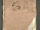 an old book with writing on it sitting on top of a table