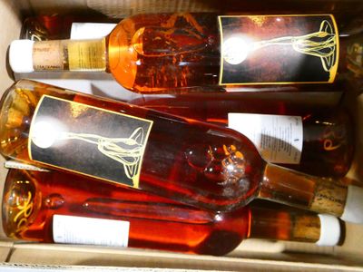 several bottles of wine are in a box with labels on them