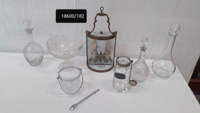 a white table with a lot of glass items on it