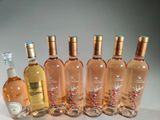 several bottles of wine are lined up in a row on a table