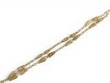 a close up of a gold bracelet with a chain on a white background