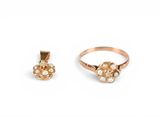 an image of two gold rings and a pearl pendant