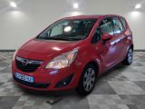 the small red car is parked in a large room