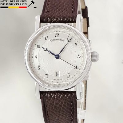 a watch that is sitting on a brown leather strap