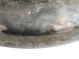 a silver plate with a bird on top of it