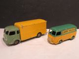 deux camions jouets assis l'un à côté de l'autre sur une table