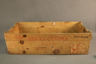 an old wooden crate sitting on top of a table next to a bottle of wine