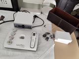 a video game system sitting on top of a table next to a lamp