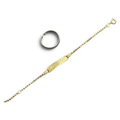 a close up of a bracelet and a ring on a white surface
