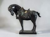 a statue of a horse with a saddle on it ' s back