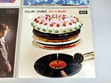 a lot of records on a table with a cake on it
