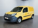 the small yellow van is parked in a large room