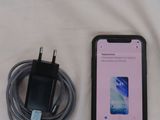 a cell phone that is sitting next to a charger