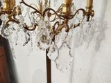 a gold chandelier with crystal drops hanging from it