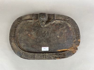une image représentant une plaque en bois sur laquelle figure un visage