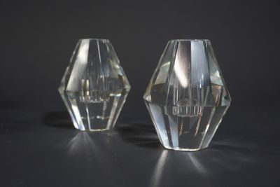 two clear glass vases sitting on a black surface