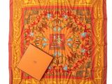 a square scarf with an orange box on top of it