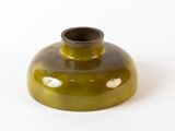 a green vase that is sitting on a white surface