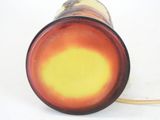 underside view of a red and yellow glass vase with a gold rim