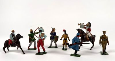many figurines of men riding on horses and horses