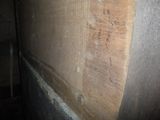a close up of a wall with a wooden panel