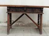 a wooden table with two drawers on top of it