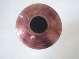 a brown vase with a black hole in it