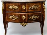 a marble top chest of drawers on a stand