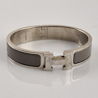 an image of a black and silver bracelet with a silver buckle
