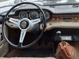 a dashboard and steering wheel of a car with a bag in it