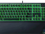 a close up of a keyboard with green lights on it