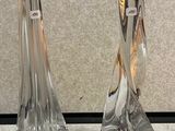 two glass candlesticks that are sitting on a table