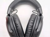 a pair of black headphones on a white surface