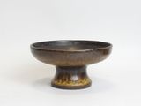 a brown bowl sitting on top of a white table