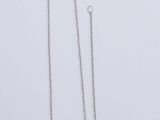 a close up of a necklace and a pair of earrings on a white surface