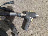 an image of a corded hose and a corded gun on the ground