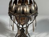 a silver bowl with spoons and spoon spoons on it