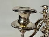 a silver candle holder with two candles on it