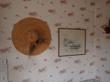 a hat hanging on the wall above a crib
