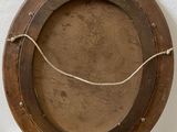 a wooden plate with a rope around it on a shelf