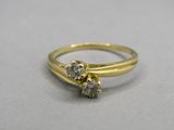 gros plan d'une bague en or ornée de deux diamants