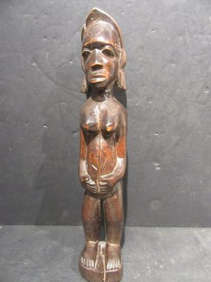 an old wooden statue of a woman holding a baby in her arms