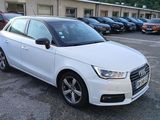 a white audi car parked in a parking lot